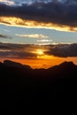 Sunset. The sun above the line of mountains Royalty Free Stock Photo