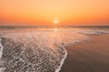 Sunset Sun Above Sea. Natural Sunrise Sky Warm Colors Over Ripple Sea. Ocean Water Foam Washing Sandy Beach At Sunset Royalty Free Stock Photo