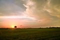 Sunset and clouds observing over field