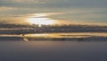 The setting sun through the fog, over the snow-covered field Royalty Free Stock Photo