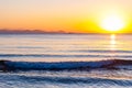 The sunset sun is going down behind the horizon. Tyrrhenian Sea bay with Elba island on the background at the sunset. Cala Violina Royalty Free Stock Photo