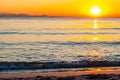 The sunset sun is going down behind the horizon. Tyrrhenian Sea bay with Elba island on the background at the sunset. Cala Violina Royalty Free Stock Photo