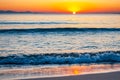 The sunset sun is going down behind the horizon. Tyrrhenian Sea bay with Elba island on the background at the sunset. Cala Violina