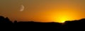 Sunset with sun and moon Royalty Free Stock Photo
