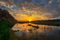 Sunset sun over the river with the sky, with beautiful clouds and stunning reflection in the water. Royalty Free Stock Photo