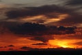 A sunset through dark storm clouds. Royalty Free Stock Photo