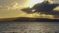 Sunset with sunbeams along a Maui beach