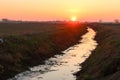 Sunset sunlight horizon classic generic Po Valley landscape panorama nature ditch river ice winter Royalty Free Stock Photo