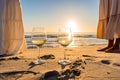 Sunset or sunrise beach party scene with two unrecognizable multiracial boho girls wearing long white dress barefoot on the ocean