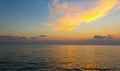 Sunset sunrise colors the cloud in orange over the sea surface