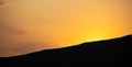 Sunset, sunrise over mountains silhouette. Scattered clouds on the sky background, space, banner. Royalty Free Stock Photo