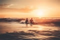 Sunset surf buddies: A wide-angle shot of a couple surfing at sunset, with golden light