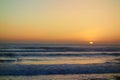 Sunset in Taghazout with a surfer in the background, Morocco