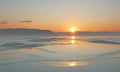 A sunset is taking place over a body of water, with the sun setting in the background. Royalty Free Stock Photo