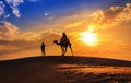 Tourist on camel safari in silhouette at the Thar desert Jaisalmer Rajasthan, India Royalty Free Stock Photo