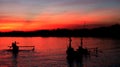 Sunset with three boat silhouettes