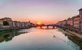 Sunset time in Florence, Italy. Bright sky over Arno river and medieval bridge. Royalty Free Stock Photo