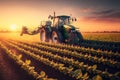 Sunset tractor watering soybeans. Sow