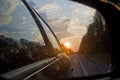 Sunset in a traffic jam on the road through the right side mirror in the car Royalty Free Stock Photo