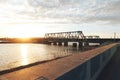 The sunset train passes the railway bridge