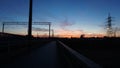 Sunset at the train stop with beautiful deep blue sky and red clouds. Wide Royalty Free Stock Photo