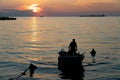 sunset in Trieste with silhouette of a man in his boat coming back from the Mediterranean sea Royalty Free Stock Photo