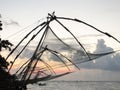 Sunset at tropical beach. Ocean coast landscape with Chinese fishing nets silhouette at Cochin. Kerala backwaters South India Royalty Free Stock Photo