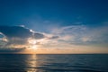 Sunset on tropical beach sea ocean with sunrise clouds. Banner for travel vacation. Scenery sky and reflection rays in