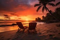 sunset on a tropical beach with two lounging chairs side by side Royalty Free Stock Photo