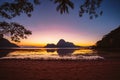 Sunset on a tropical island with silhouette of palm trees. El Nido bay. Philippines Royalty Free Stock Photo