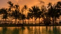 sunset at a tropical swimming pool with palm trees at the island of Koh Kood Thailand Royalty Free Stock Photo