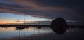 Sunset at twilight over Morro Bay Harbor boats and Morro Rock on the central California coast in California USA Royalty Free Stock Photo