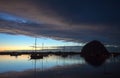 Sunset at twilight over Morro Bay Harbor boats and Morro Rock on the central California coast in California USA Royalty Free Stock Photo