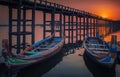 Sunset in U Bein bridge with vintage boat