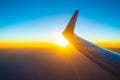 Sunset under flying airplane wing Royalty Free Stock Photo