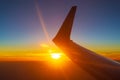 Sunset under flying airplane wing Royalty Free Stock Photo