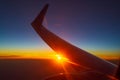 Sunset under flying airplane wing Royalty Free Stock Photo