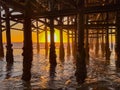 sunset under an ocean pier Royalty Free Stock Photo