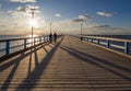 Sunset and vacationers on the bridge of Palanga on the Baltic Sea in Klaipeda, Lithuania