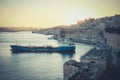 Sunset in Valleta, Malta. Old harbour at sunset with overview of Royalty Free Stock Photo