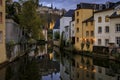 Pastel houses reflecting in Alzette river in Luxembourg old town, UNESCO World Heritage Site and the city wall at sunset Royalty Free Stock Photo