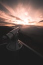 sunset view in the austrian mountains with a coin operated binoculars