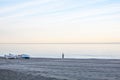 Sunset view of the beach with fisherman and boats Royalty Free Stock Photo