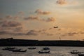 Sunset view of the beach with a plane silhouette taking off Royalty Free Stock Photo