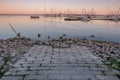 Sunset view of brick path leading into harbour with marina in background in Burlington, Ontario