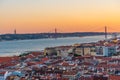 Sunset view of Bridge of 25th April and National sanctuary of Cristo Rei in Lisbon, Portugal Royalty Free Stock Photo