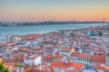 Sunset view of Bridge of 25th April and National sanctuary of Cristo Rei in Lisbon, Portugal Royalty Free Stock Photo