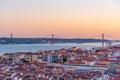 Sunset view of Bridge of 25th April and National sanctuary of Cristo Rei in Lisbon, Portugal Royalty Free Stock Photo