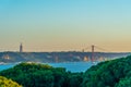 Sunset view of Bridge of 25th April and National sanctuary of Cristo Rei in Lisbon, Portugal Royalty Free Stock Photo