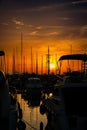 Sunset view at a busy shipyard with water reflecting fiery color Royalty Free Stock Photo